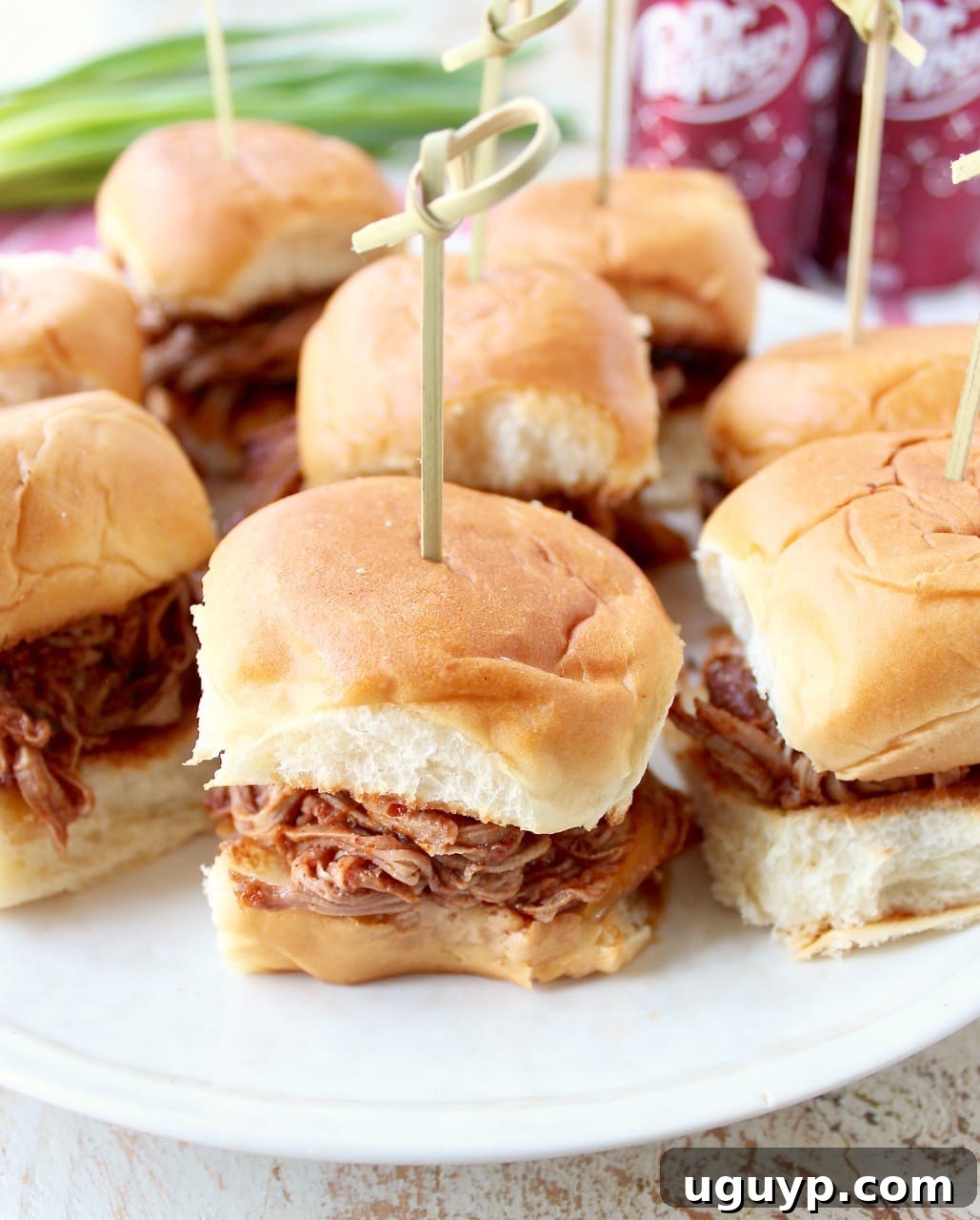 A tray of Dr Pepper Pulled Pork Sliders, beautifully arranged and ready for serving, highlighting their appeal as party food.