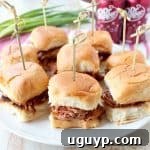 In this tasty slider recipe, pork tenderloin is covered in a delicious spice rub, slow cooked in a Dr Pepper BBQ Sauce, shredded & served on Hawaiian rolls.