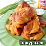 Buffalo Cheesy Garlic Knots, a delicious appetizer filled with cheese and smothered in buffalo sauce.