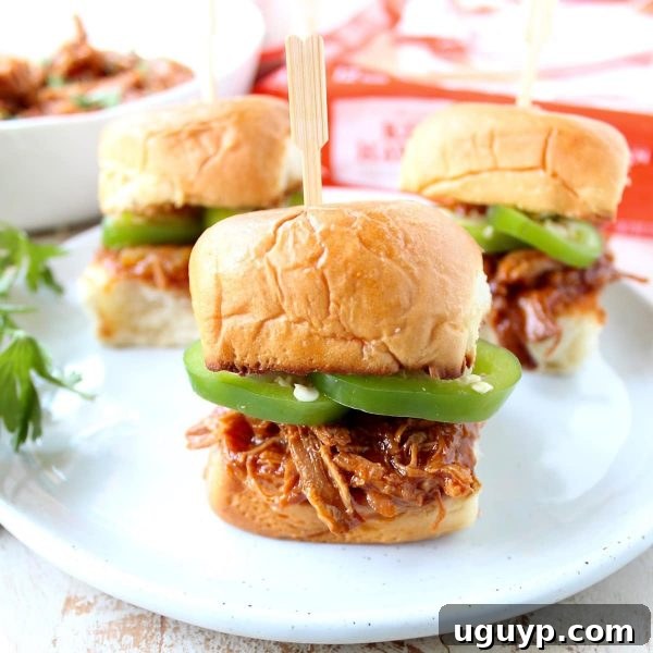 Close-up of a slow cooker filled with chicken breasts, diced pineapple, and King's Hawaiian Original Sweet Pineapple BBQ Sauce.