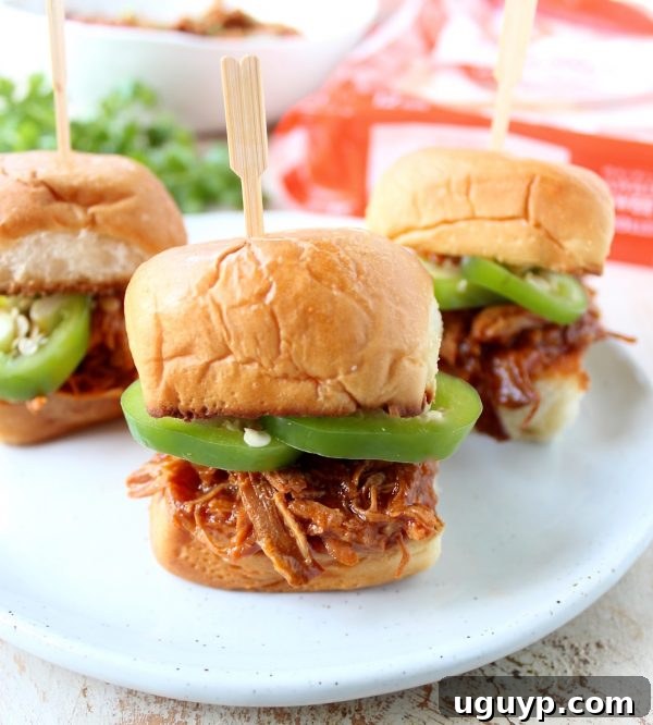 A platter of perfectly assembled Hawaiian Chicken Sliders with various toppings, ready to be enjoyed.