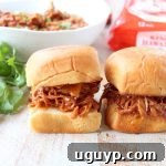 Hawaiian Chicken Sliders with shredded chicken and pineapple on sweet rolls.