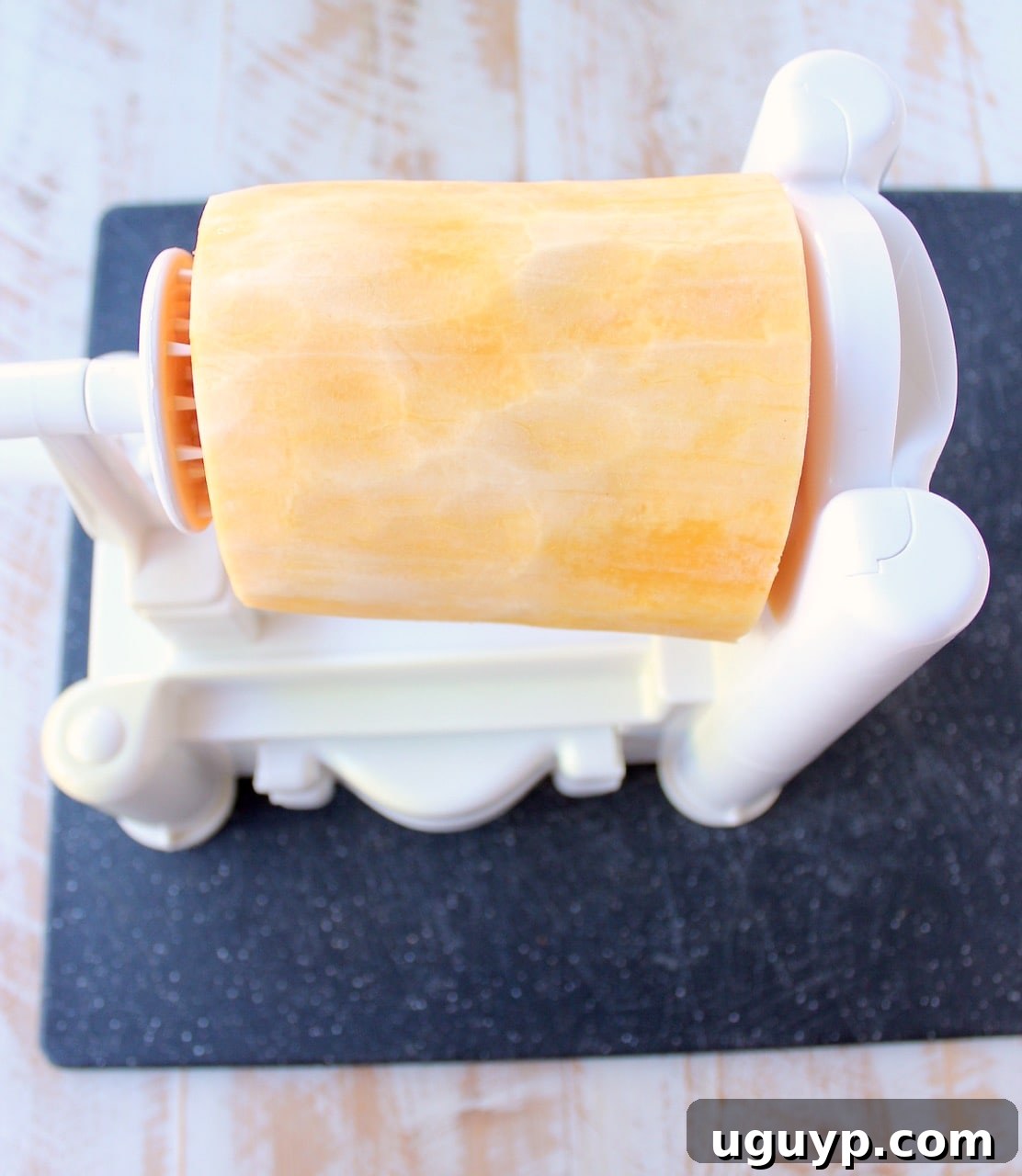peeled butternut squash in a spiralizer machine