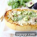 Green chili chicken is stuffed in roasted spaghetti squash and topped with gooey, melted pepper jack cheese for a delicious gluten free fall meal!