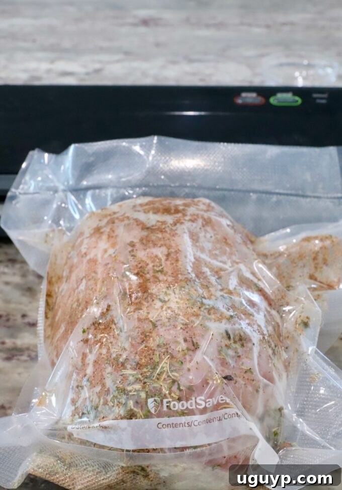 Vacuum-sealed turkey breast generously coated with seasonings in a bag, ready for the water bath.