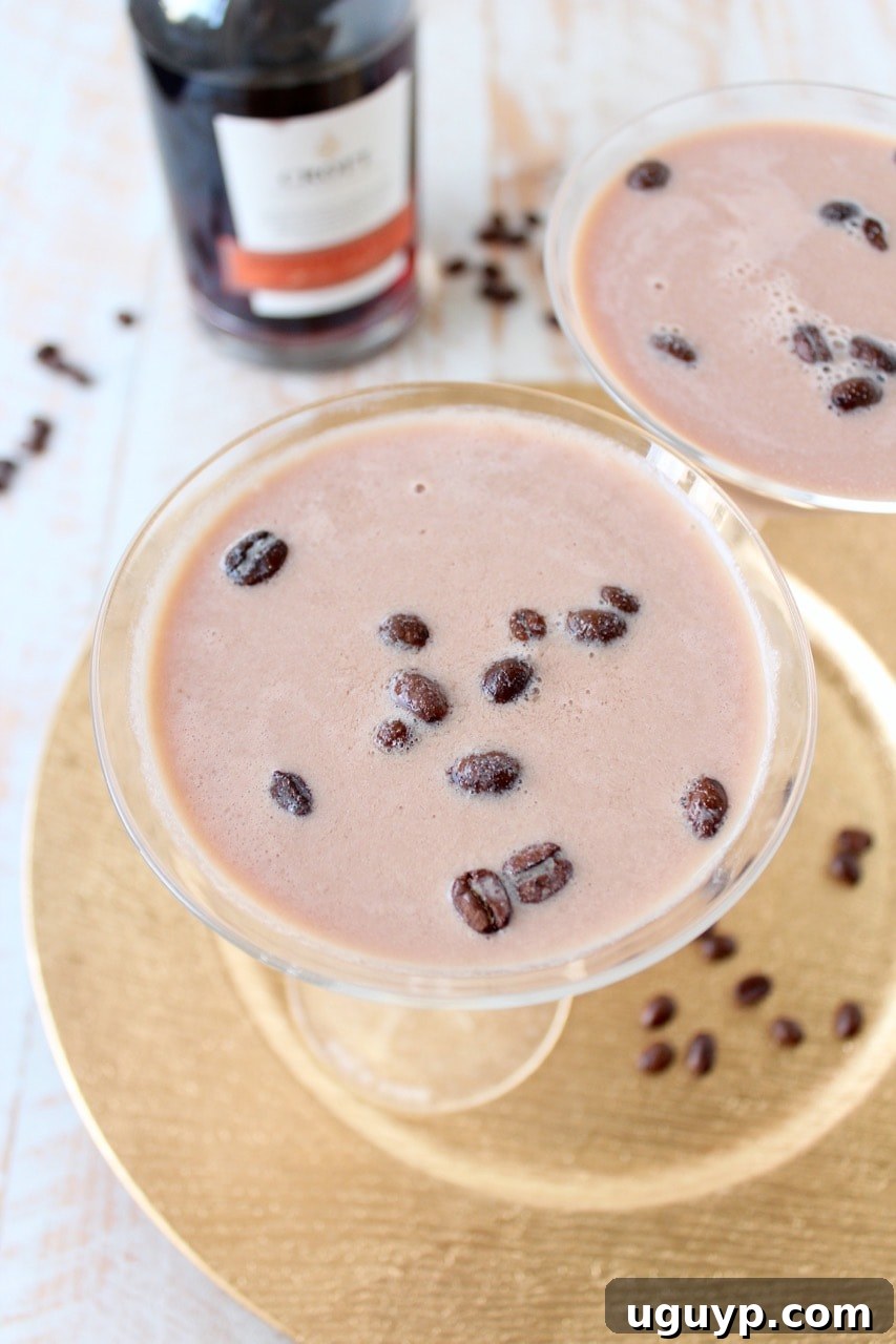 A stunning Port Coffee Martini in a classic martini glass, garnished with whole coffee beans, presenting an elegant and inviting after-dinner cocktail.