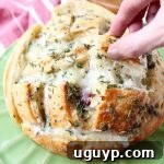 Leftover Thanksgiving turkey & cranberry sauce is made into a delicious pull apart bread recipe filled with mozzarella cheese & topped with rosemary butter!