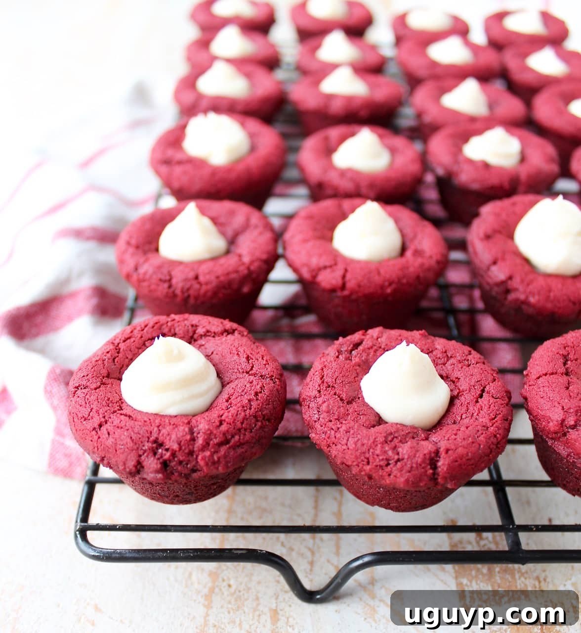Red velvet cookie cups filled with cream cheese frosting are a delicious and adorable dessert recipe that's also easy to make! Perfect for Valentine's Day, birthdays or any day you're craving a sweet treat!