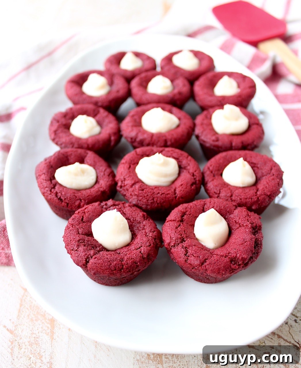 Red velvet cookie cups filled with cream cheese frosting are a delicious and adorable dessert recipe that's also easy to make! Perfect for Valentine's Day, birthdays or any day you're craving a sweet treat!