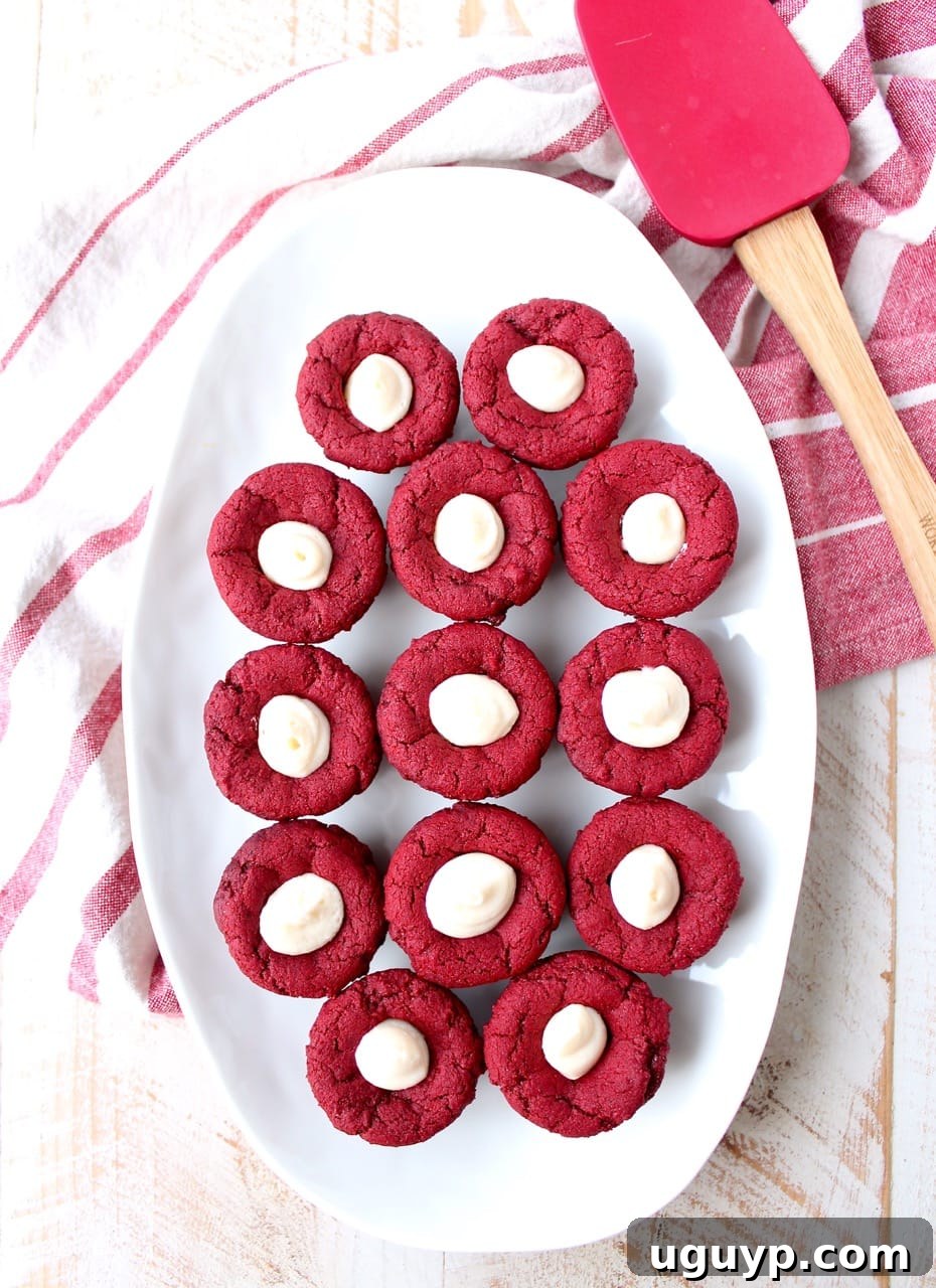 Red velvet cookie cups filled with cream cheese frosting are a delicious and adorable dessert recipe that's also easy to make! Perfect for Valentine's Day, birthdays or any day you're craving a sweet treat!