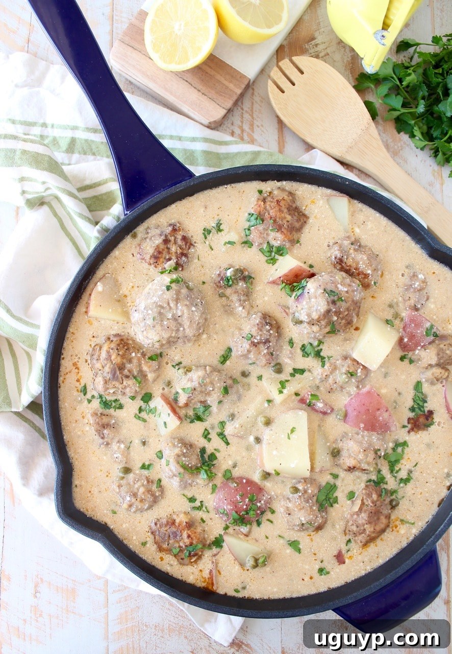 Hearty German meatballs and tender potatoes in a creamy white caper sauce, an incredibly flavorful and easy one-pot dinner recipe.