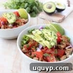 Taco seasoned ground turkey cooked with peppers, onions and tomatoes, tops this gluten free, dairy free, Whole30 taco salad recipe, made in just 20 minutes!