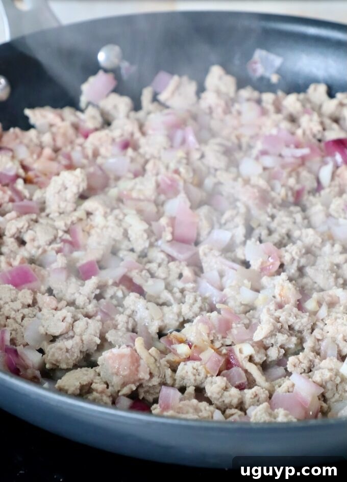cooked ground turkey in skillet with onions and garlic