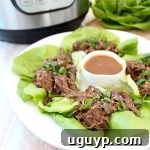 Whole30 Instant Pot Thai Beef served in fresh lettuce wraps.