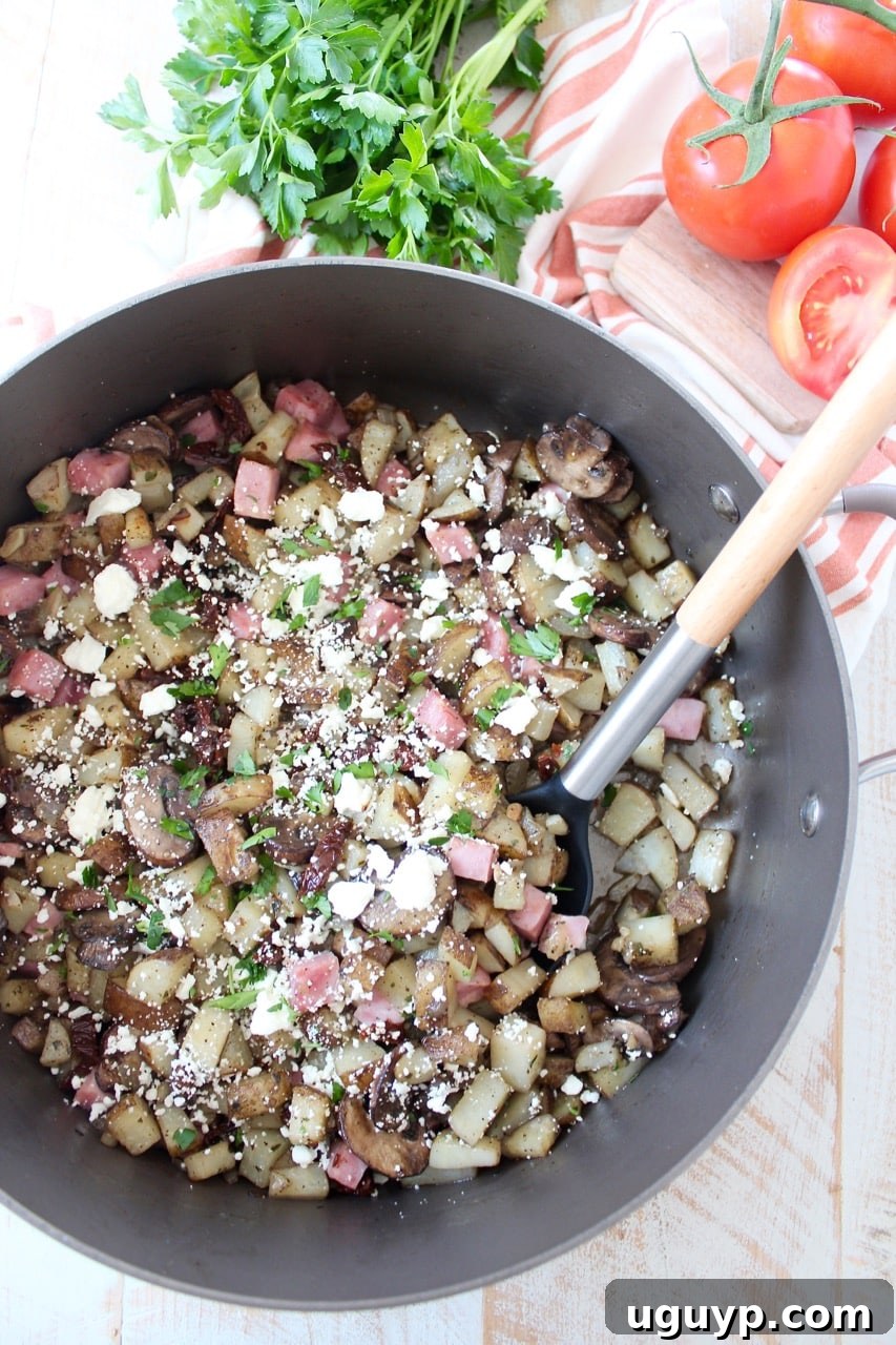 Close-up shot of the ham hash cooking in a skillet, showing the diced potatoes, onions, and ham getting golden brown and crispy, a crucial step for perfect hash texture.