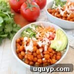 Buffalo chickpeas, quinoa and veggies are tossed together in this healthy, gluten free, vegan buddha bowl recipe, topped with an easy homemade vegan ranch dressing, all made in just 20 minutes!