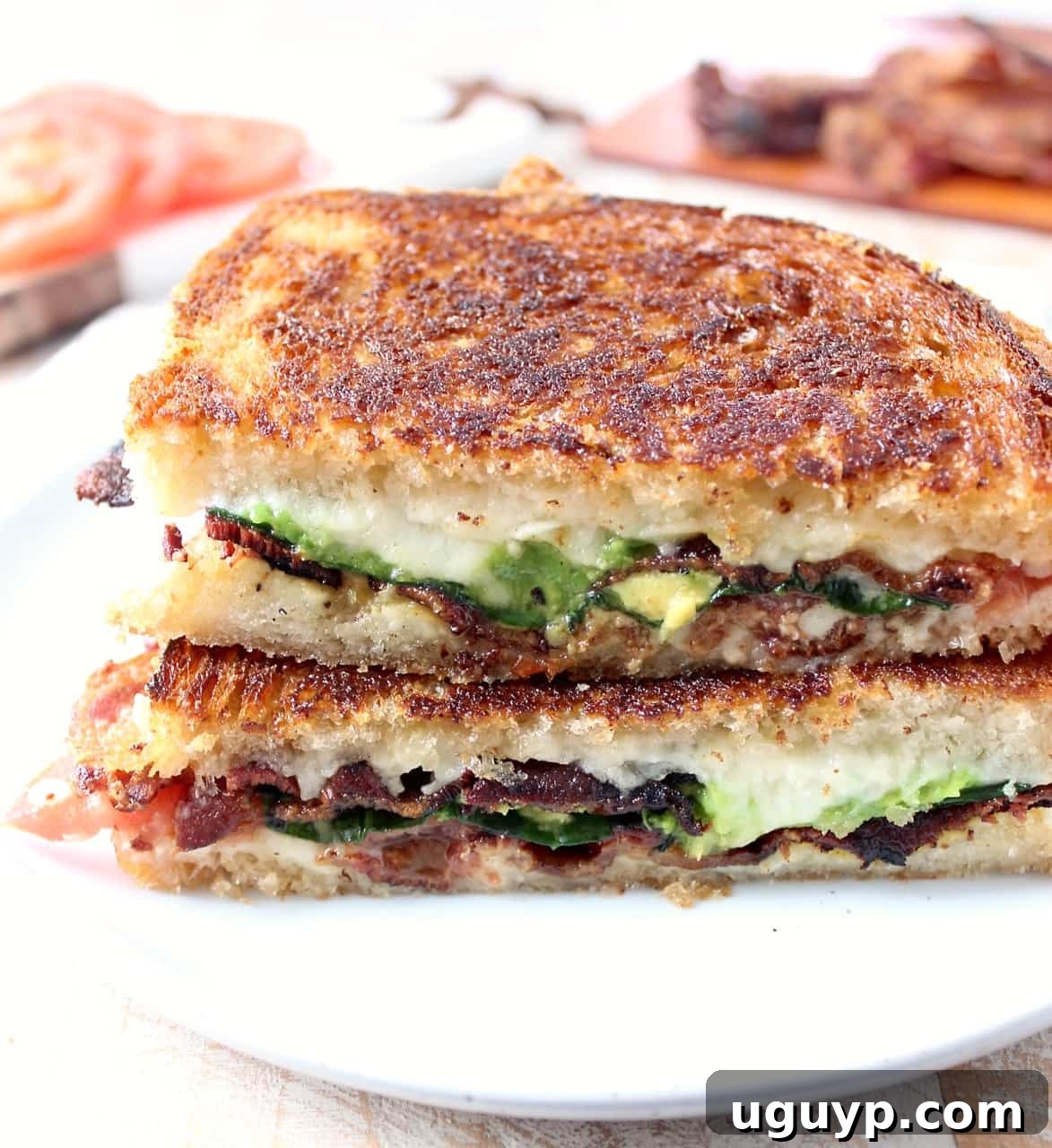 Crispy bacon, creamy avocado and juicy tomatoes are combined in this scrumptious gruyere and avocado grilled cheese sandwich recipe!