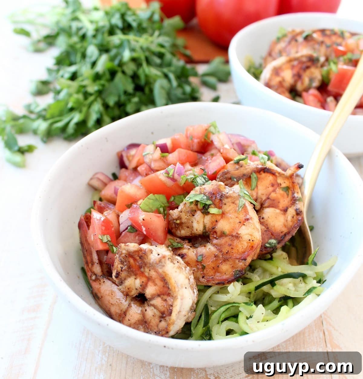 Delicious Italian marinated grilled shrimp is topped with homemade tomato basil bruschetta and served over sautéed zucchini noodles in this healthy, Whole 30 and gluten free Shrimp Bruschetta Zoodle Bowl recipe!
