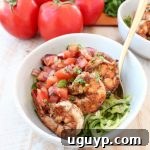 Delicious Italian marinated grilled shrimp is topped with homemade tomato basil bruschetta and served over sautéed zucchini noodles in this healthy, Whole 30 and gluten free Shrimp Bruschetta Zoodle Bowl recipe!