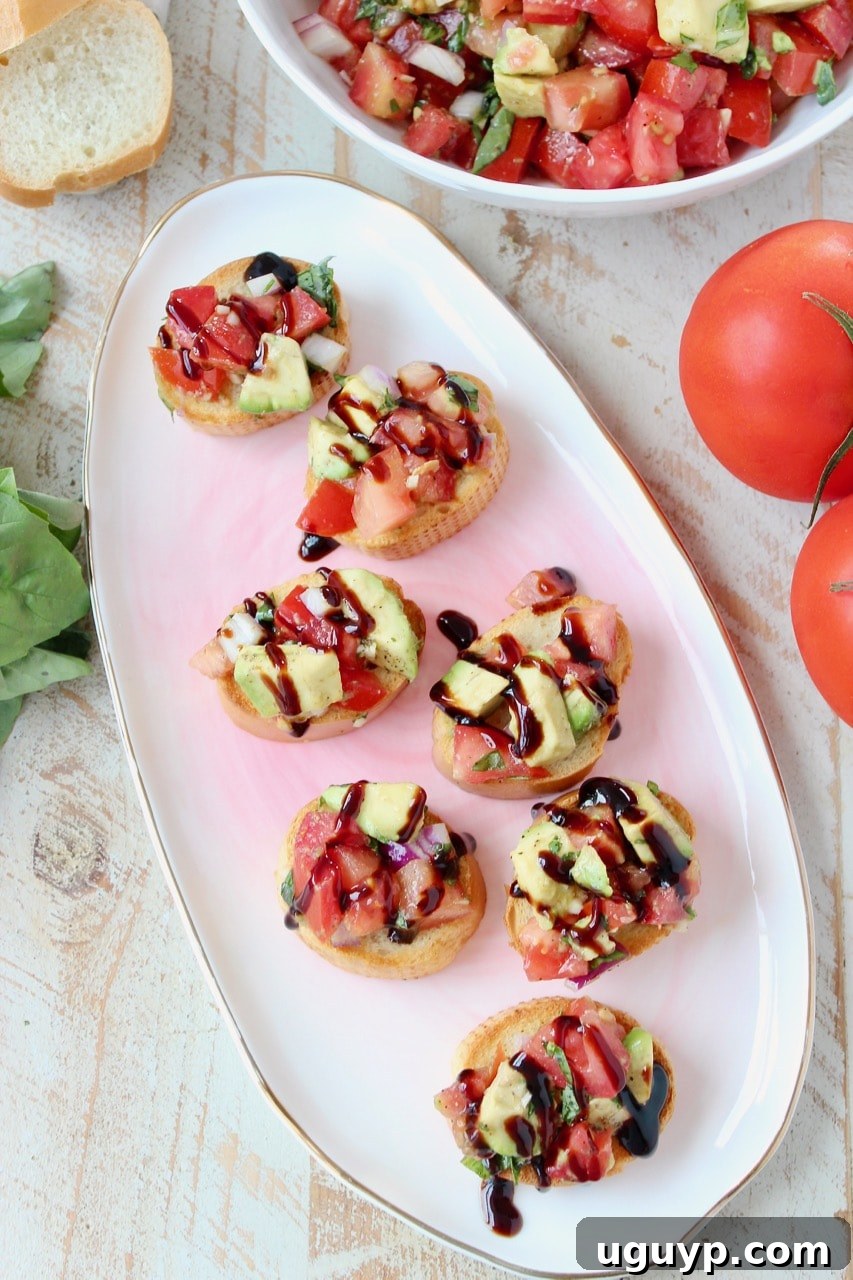 Crispy baguette slices adorned with a generous topping of creamy avocado bruschetta, finished with a luscious balsamic reduction drizzle.