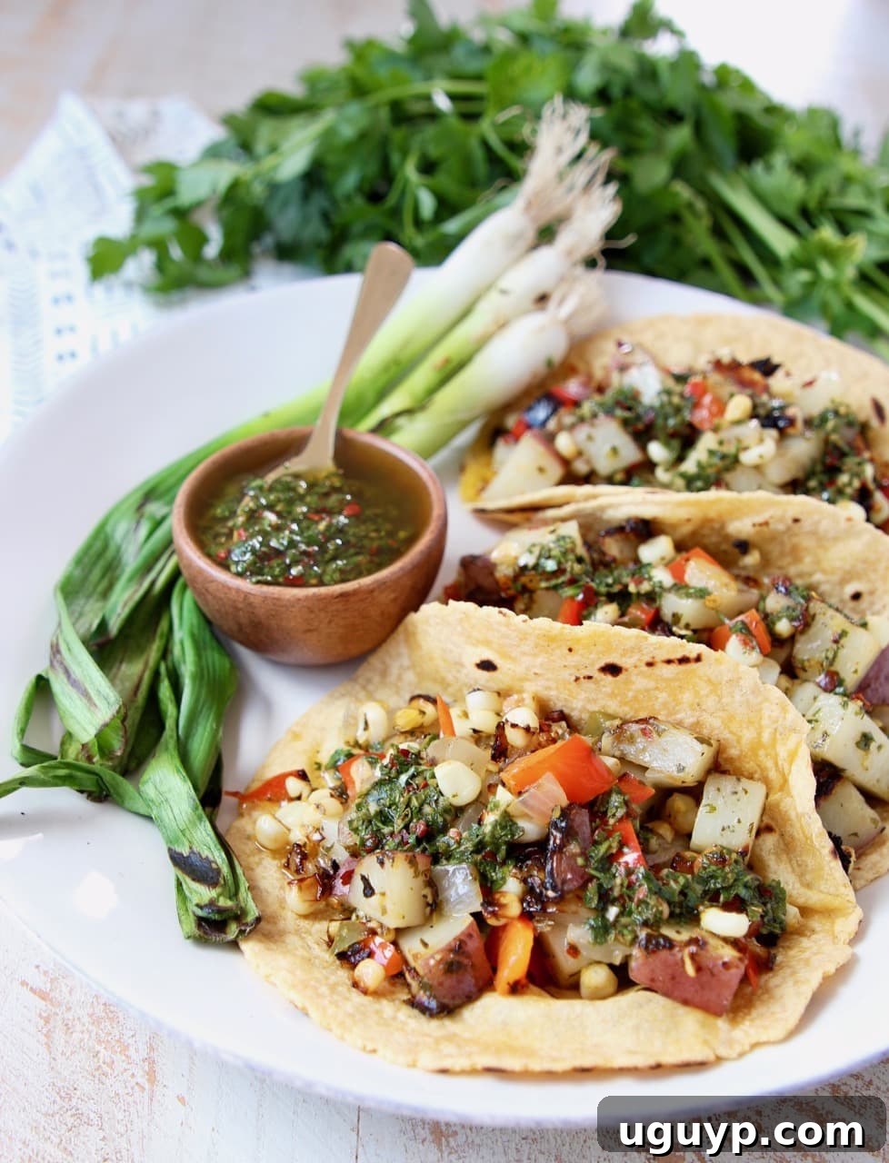 Vibrant Vegan Tacos overflowing with grilled sweet corn, tender potatoes, and colorful bell peppers, ready to be enjoyed.
