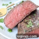 sliced medium rare sous vide steak on plate with fork