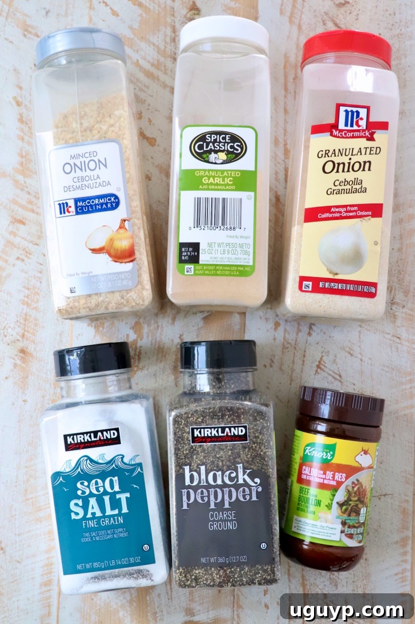 Arrangement of various spices including minced onions, garlic powder, and onion powder on a white wooden board, ready to be combined for the homemade French Onion Dip Mix, illustrating the simple components.