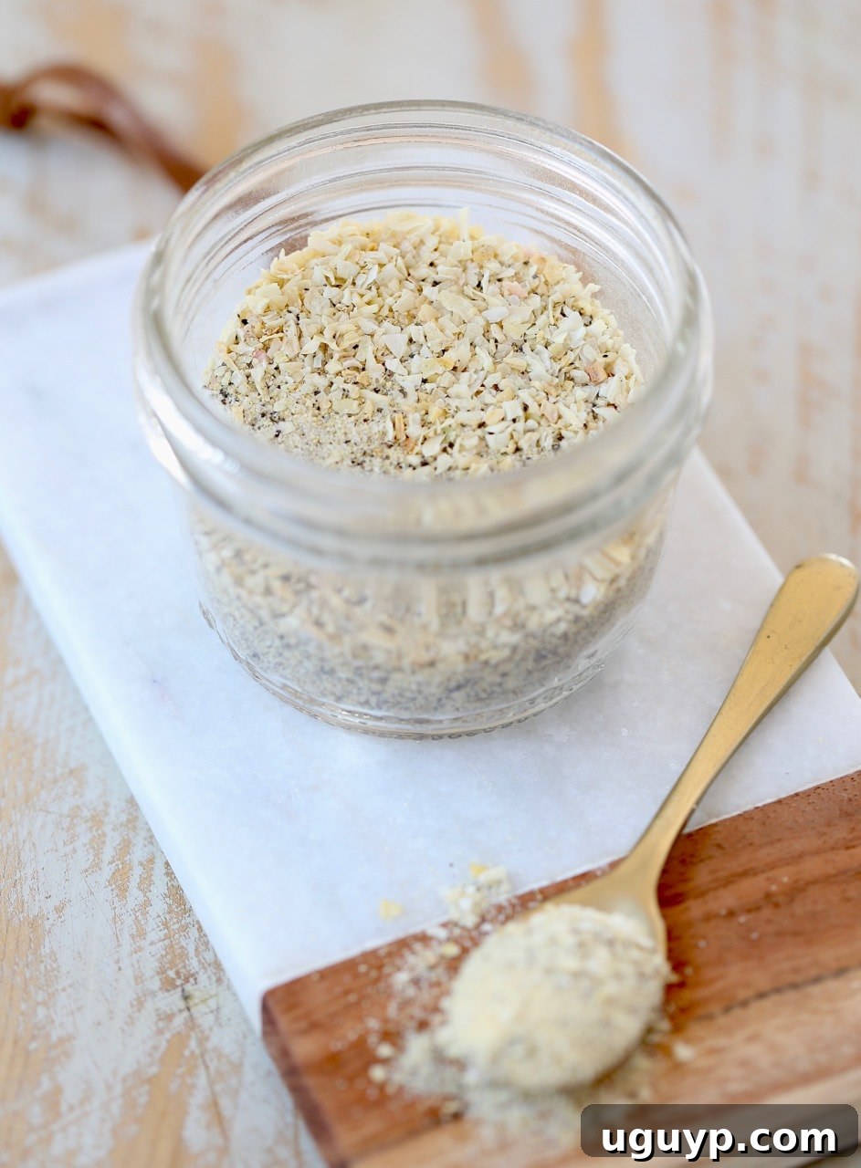 Homemade French Onion Dip Mix in a sealed mason jar, placed on a elegant marble cutting board, ready for storage and future use, showcasing its simple and attractive presentation.