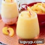 Frozen Peach Sangria in Glasses on Copper Tray with Fresh Peaches in Red Colander
