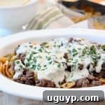 Frito Cheesesteak Pie with ground beef and creamy provolone sauce in casserole dish