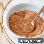 Homemade taco seasoning mixed in a bowl with a spoon, ready to be stored.