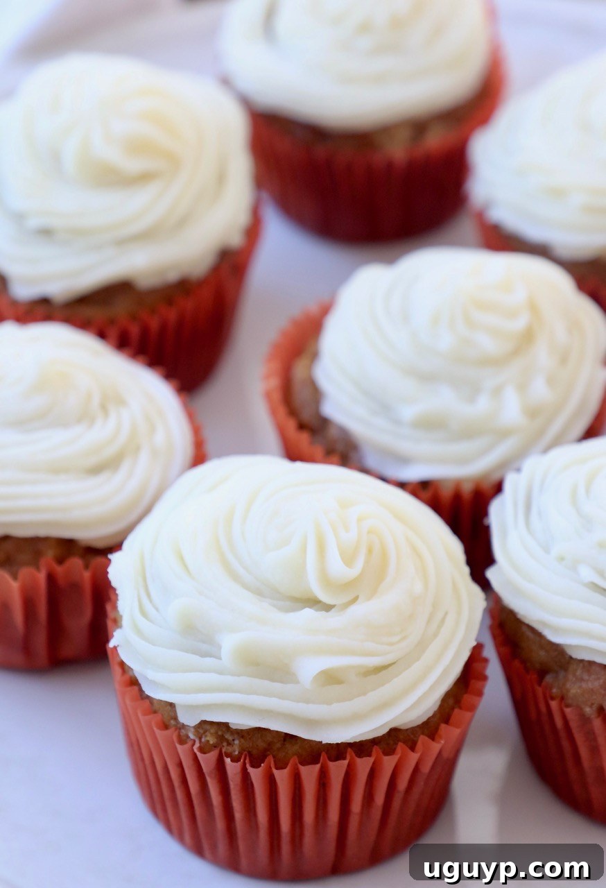 Plate of perfectly frosted pumpkin cupcakes with rich cream cheese topping