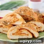 Easy Buffalo Cheesy Pizza Bread sliced on green plate
