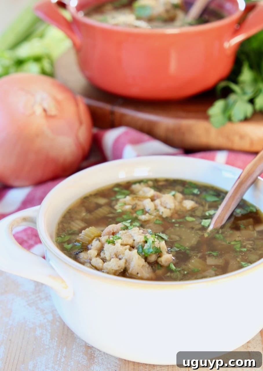 Instant Pot Turkey Soup with stuffing dumplings served in white and orange bowls, with fresh celery, yellow onion, and a wooden cutting board in the background on a red and white striped towel.