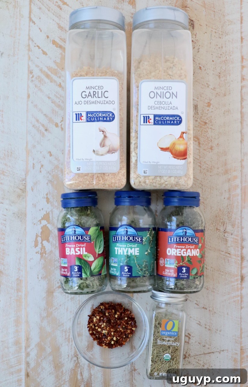 containers of herbs and spices lined up on white wood board