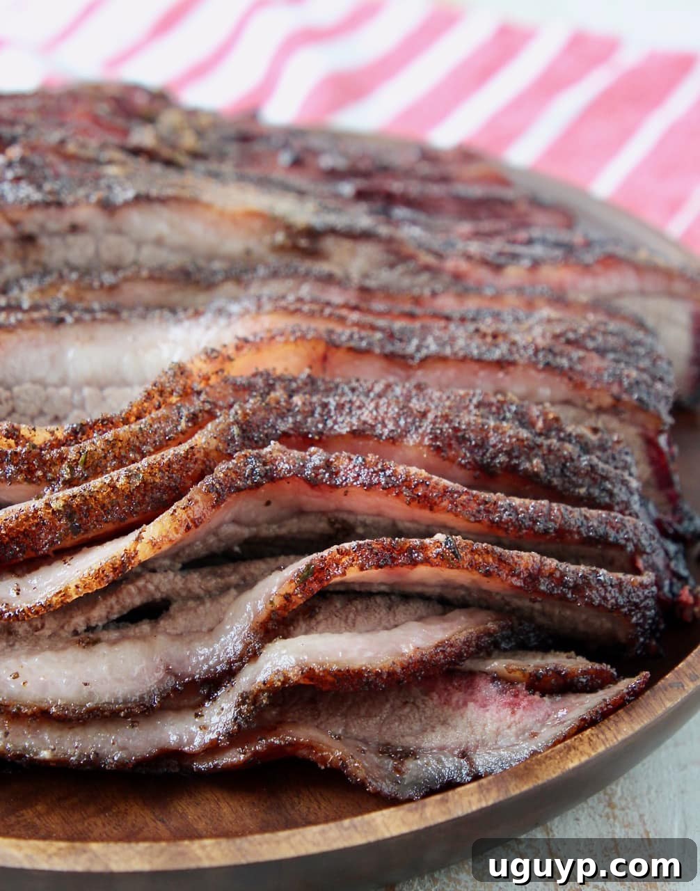 Close-up view of a perfectly smoked brisket, sliced to reveal its tender, juicy interior and beautiful smoke ring.