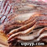 Sliced smoked brisket on wood tray