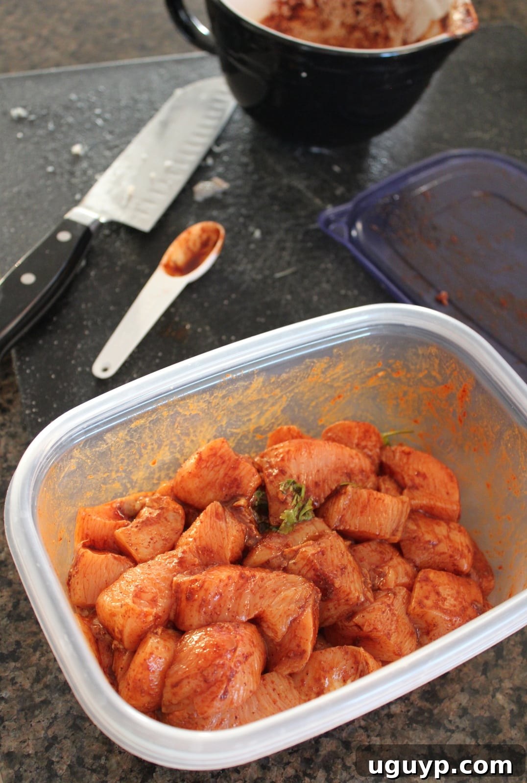 Diced chicken breast pieces marinating in the Chipotle Lime Fajita Chicken Marinade in a bowl.