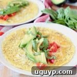 Avocado omelette topped with fresh basil, sliced avocado and fresh diced tomatoes