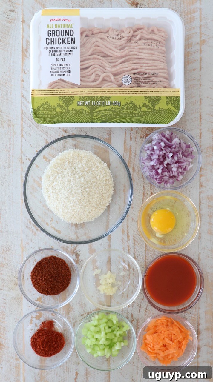 ingredients for buffalo chicken burgers on white wood board
