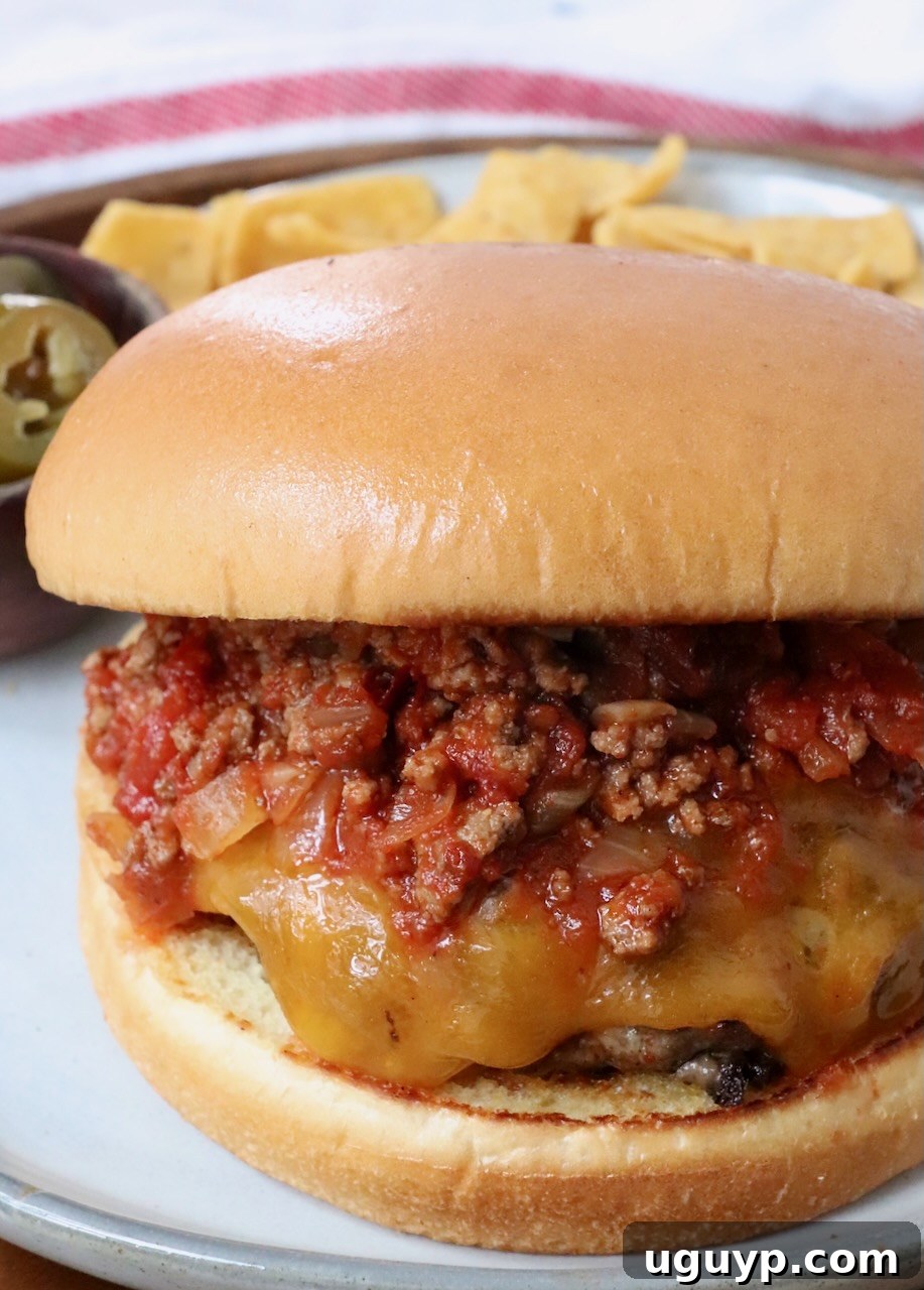 A delicious chili cheeseburger served on a plate