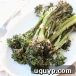 Roasted broccolini on white plate