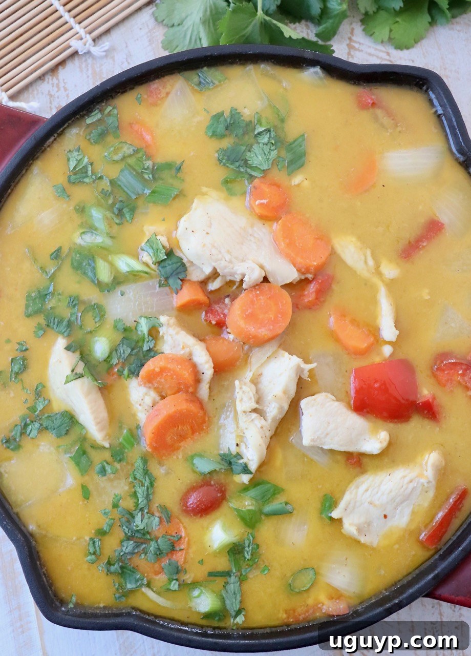 A vibrant bowl of homemade Thai Yellow Curry with chicken, bell peppers, carrots, and a creamy sauce, served with jasmine rice.
