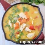 A bowl of Thai Yellow Curry with chicken, bell peppers, carrots, and a creamy sauce, served with jasmine rice.