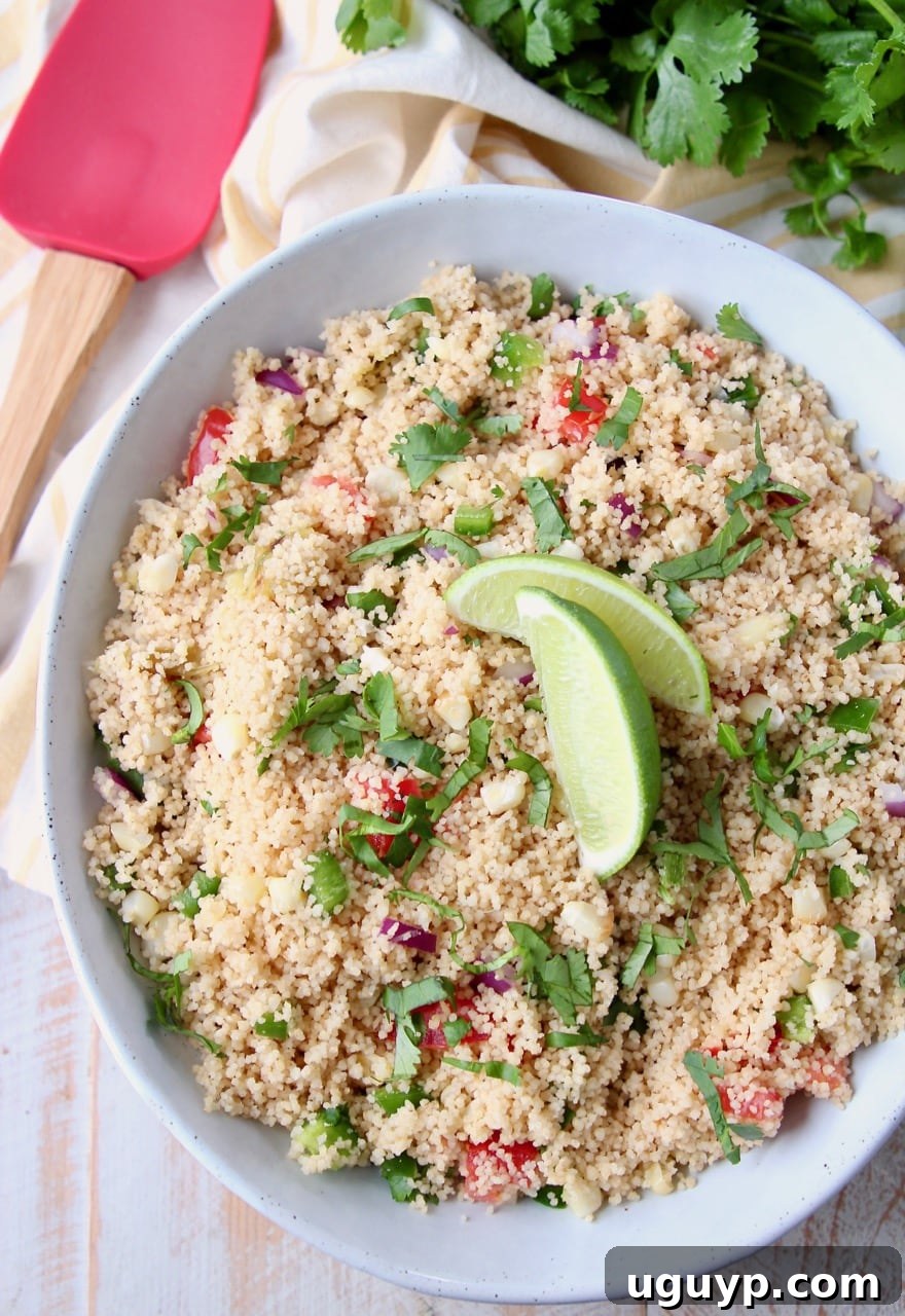 A beautifully presented bowl of Mexican couscous, garnished with a fresh lime wedge, ready to be enjoyed.