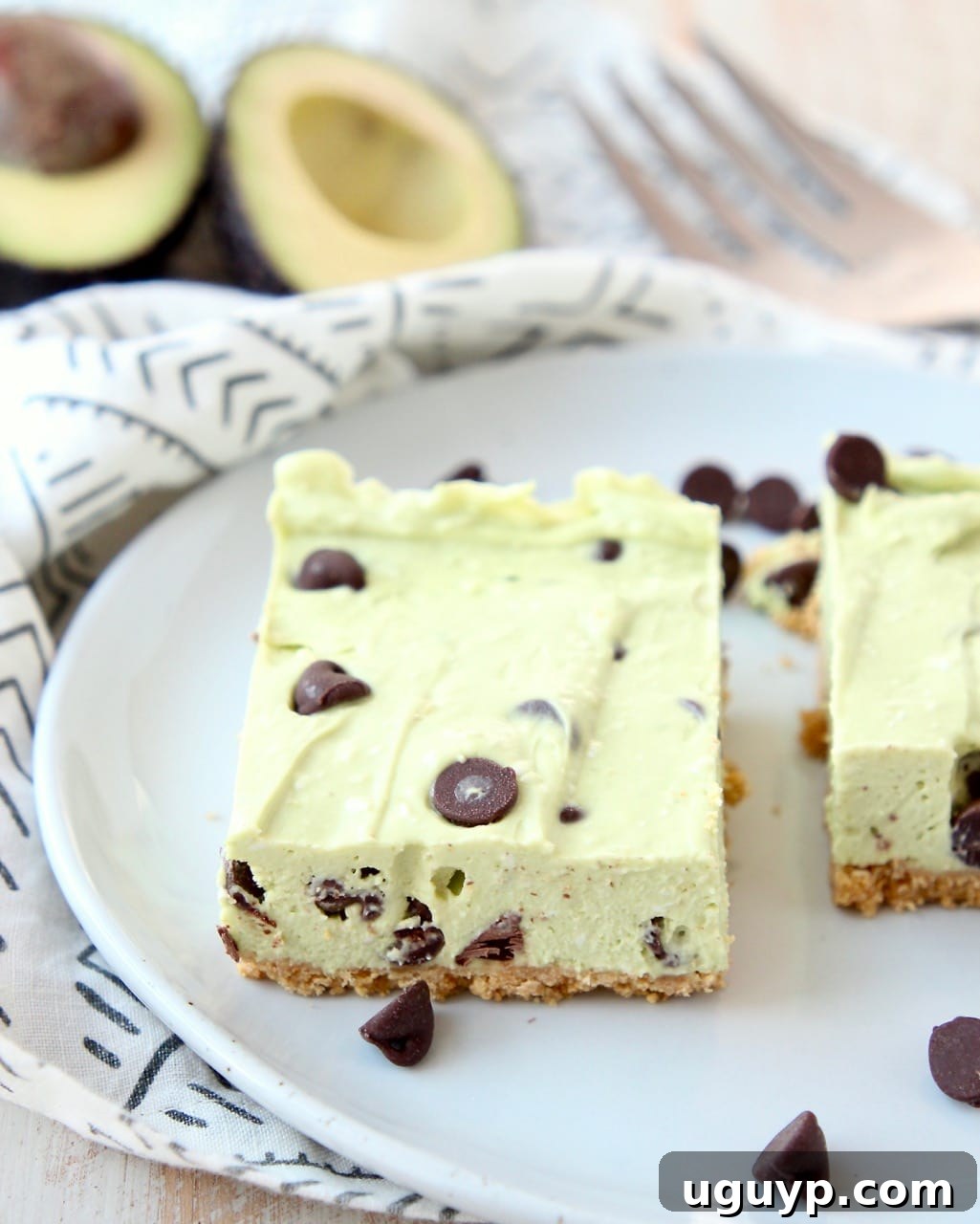 Avocado no bake cheesecake bars with chocolate chips on a plate, ready to be served.