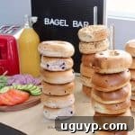 Bagel bar setup with bagels on stands and bagel bar sign in background