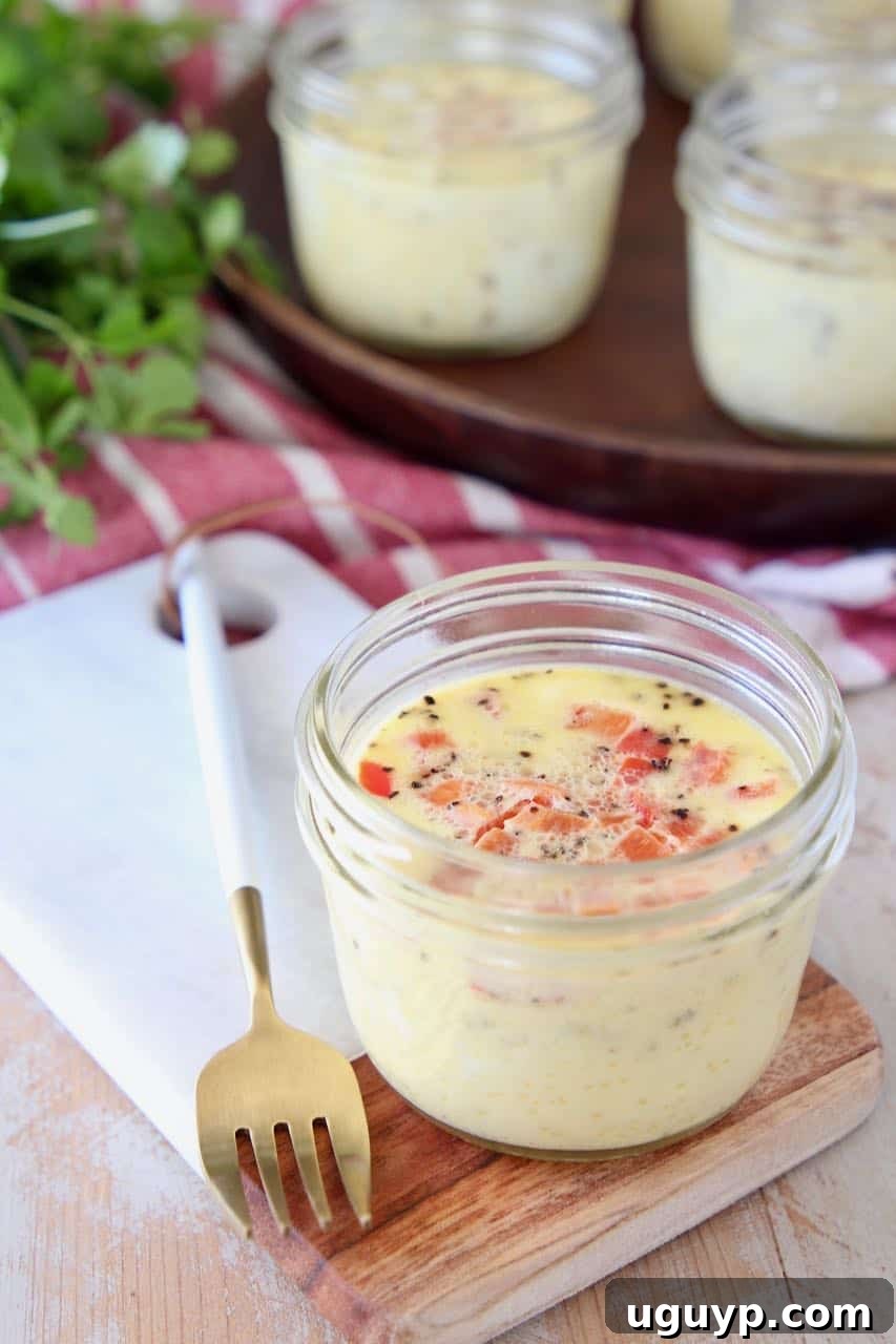 Close-up of a sous vide egg bite perfectly cooked inside a glass mason jar, showcasing its smooth, creamy texture.