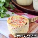 Sous vide egg bite with red bell pepper, showing a fluffy texture.