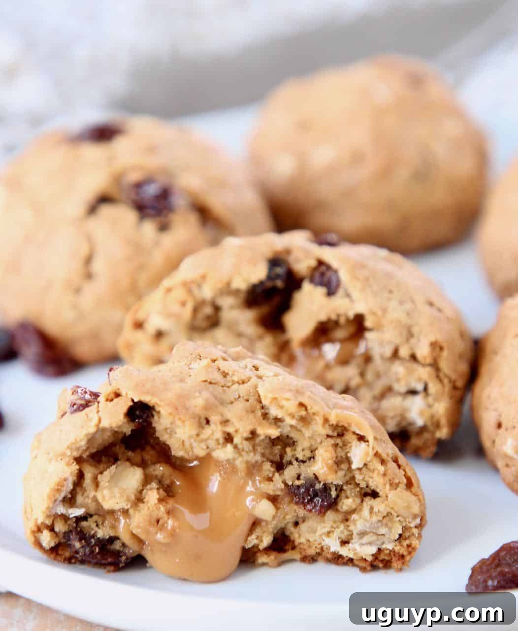 Oatmeal raisin cookie cut in half with a caramel center